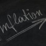 inflation with upward arrow on chalkboard