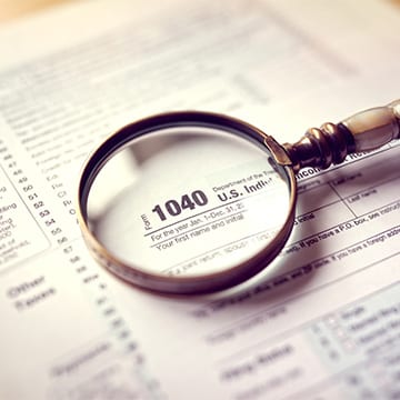 magnifying glass over 1040 tax form